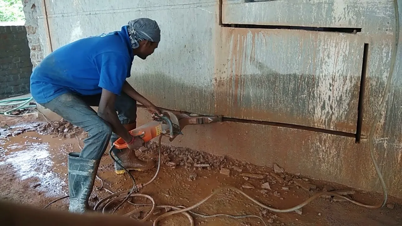 Track-mounted wall saw positioned against a concrete wall